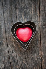 Red heart shape on a wooden background