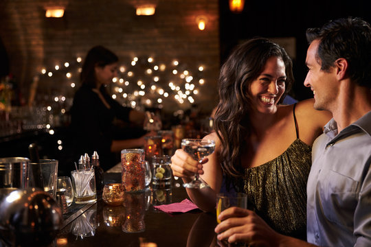 Couple Enjoying Night Out At Cocktail Bar