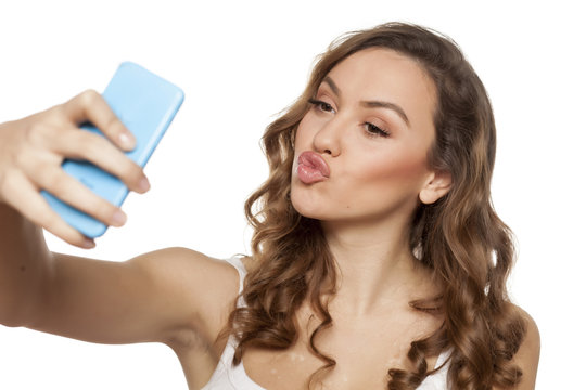 sensual young woman taking selfies