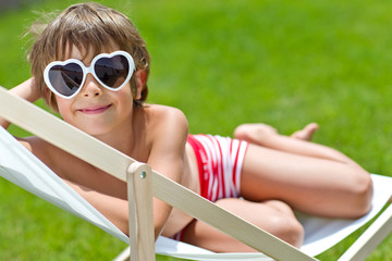 relaxing kid on chaise-longue  