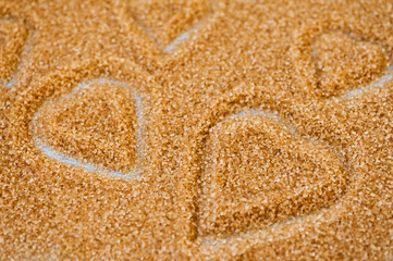 Fototapeta na wymiar Hearts in brown sugar made with cookie cutter for Valentine's Day