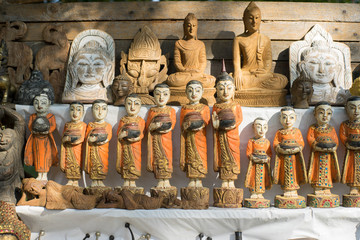 Colorful traditional puppets and image of Budha are sold as souvenirs on the street.
