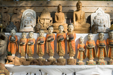 Colorful traditional puppets and image of Budha are sold as souvenirs on the street.
