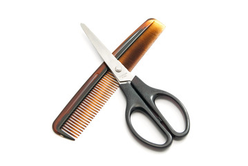 brown comb and scissors on white