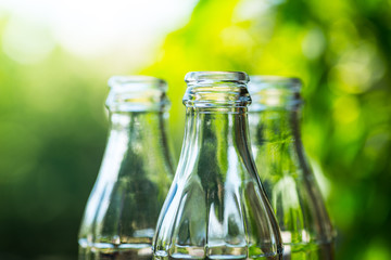 Glass bottles over the sunny background