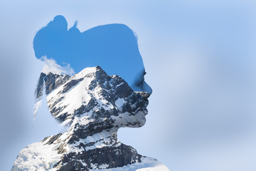 Double exposure portrait of young woman and mountain