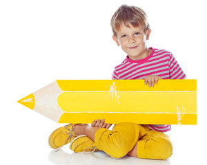 Happy kid with a big pencil in studio