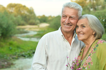 Happy senior couple  near river