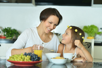 Mother and daughter eating