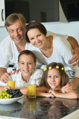 family with kids eating at table