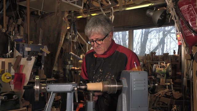 wood turner cutting shapes in wood