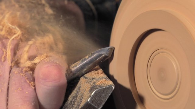 wood turner cutting shapes in wood