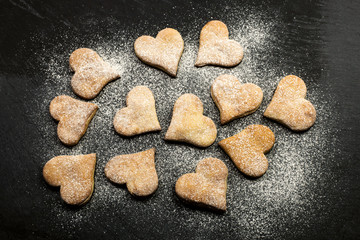 HEART COOKIES WITH SUGAR OVER SLATE SURFACE