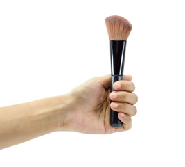 hand holding makeup brush