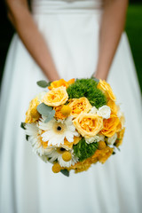 the bride holding a bouquet of yellow