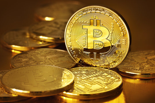Golden Bitcoins on a gold background .Photo (new virtual money )