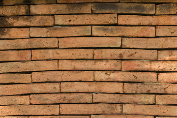 Closeup of the weathered red brick wall