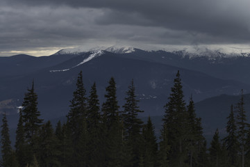 Mountain range under cloudy sky
