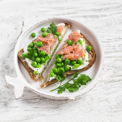 Open sandwich with soft cheese, green peas and smoked salmon. A delicious Breakfast or snack