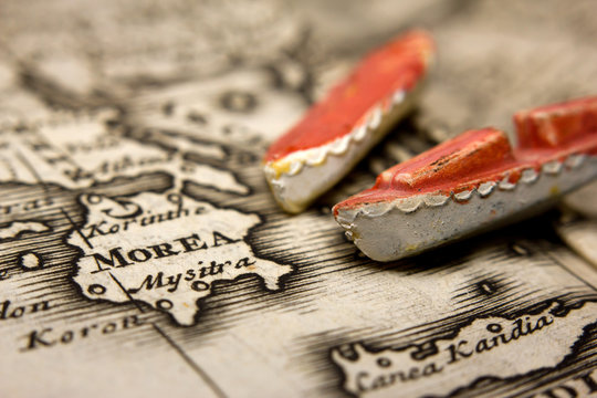A boat and an antique map of Europe representing the immigration from the East