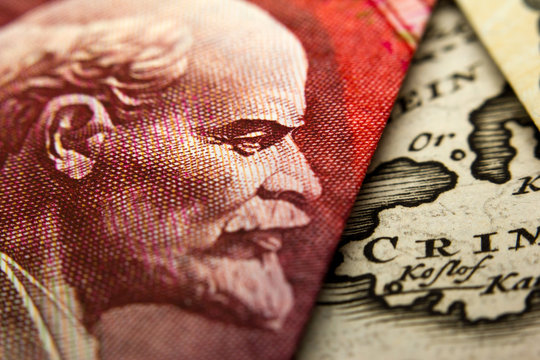 Close-up of an Russian ruble banknote (figuring Lenin) and a map showing Crimea (Crim)