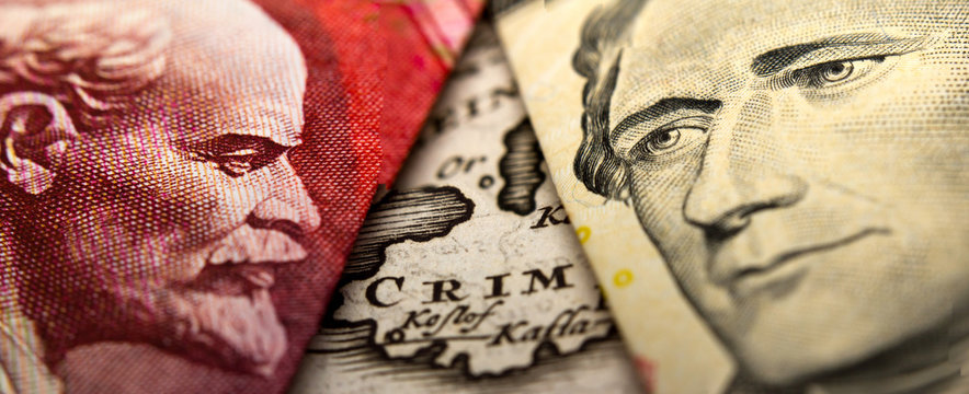 An antique map showing Crimea (Crim) in between a close-up of a Russian ruble banknote (figuring Lenin) and a 10 dollar banknote figuring Alexander Hamilton