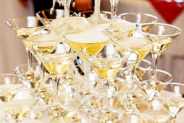 Pyramid of glasses with champagne close up