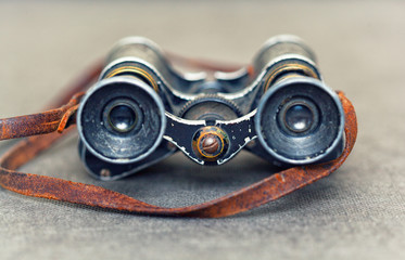 Vintage metal binoculars with a leather strap