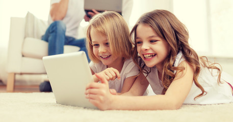 smiling sister with tablet pc and parents on back