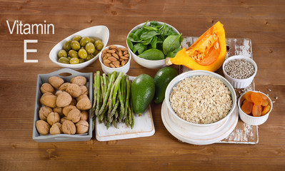 Foods high in vitamin E on  wooden board.