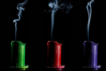candles green, red and blue are off on a dark background