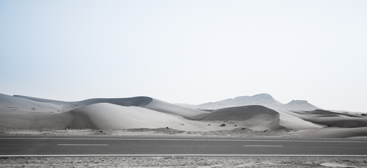 desert, sand dunes and the road in the evening