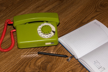 landline phone with a notebook