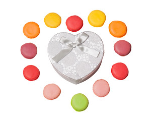 Colorful macaroons with heart shape gift box on white background