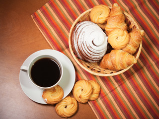 Cookies, pastries and coffee cup  on wooden background