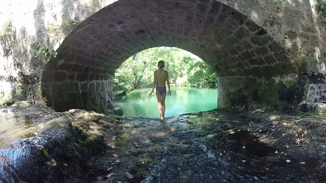 Young girl walking on cascade on Zrmanja river