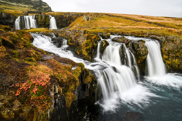 Fototapeta na wymiar Waterfall near Kirkjufell, natural landmark of Iceland