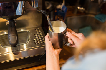 Fototapeta na wymiar close up of woman making coffee by machine at cafe