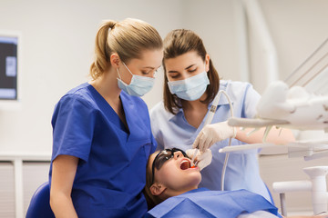 female dentists treating patient girl teeth
