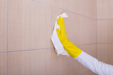 Woman cleaning bathroom tiles