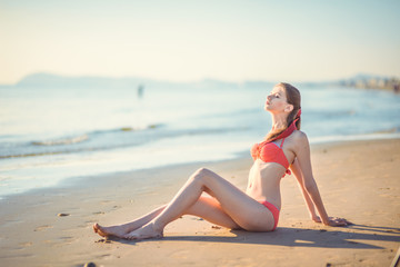 Fototapeta na wymiar Beautiful young woman bikini pinup at beach