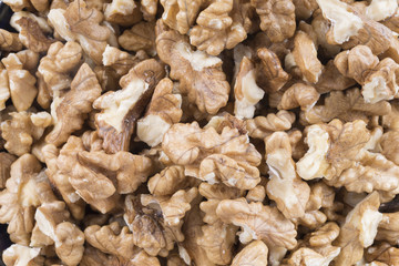 crushed walnuts background. healthy food background.