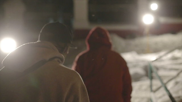 snowboarder with a snowboard in hand rises night