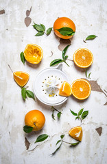 Juicer with fresh oranges. The fresh orange juice.