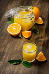 Freshly squeezed orange juice with slices of oranges.