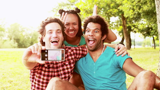 Three young friends having fun taking selfies