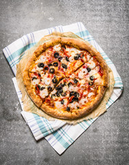 Fresh seafood pizza with shrimp. On stone table.