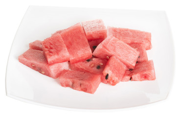 chopped pieces of watermelon in a white dish isolated