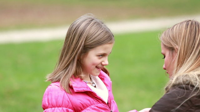 Mother zipping up daughter's jacket