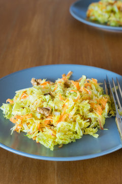 Savoy cabbage, brussels sprouts, apple, carrot and walnut salad on plate
